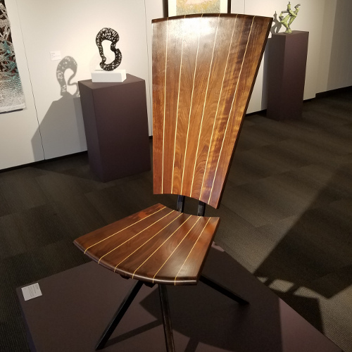 Coopered and tapered black walnut, American holly, and oil-flamed welded steel chair at the Ohio Craft Museum, Best of 2018